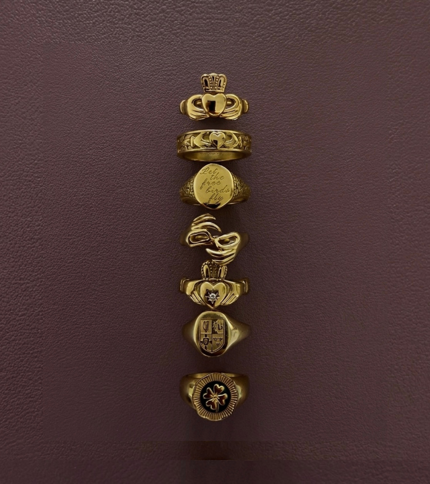 Réalta gold ring collection - stacked Irish gold rings on textured background