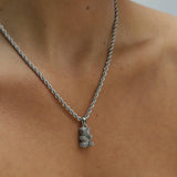 Réalta silver-toned pavé bear pendant necklace on a delicate rope chain worn around a woman's neck