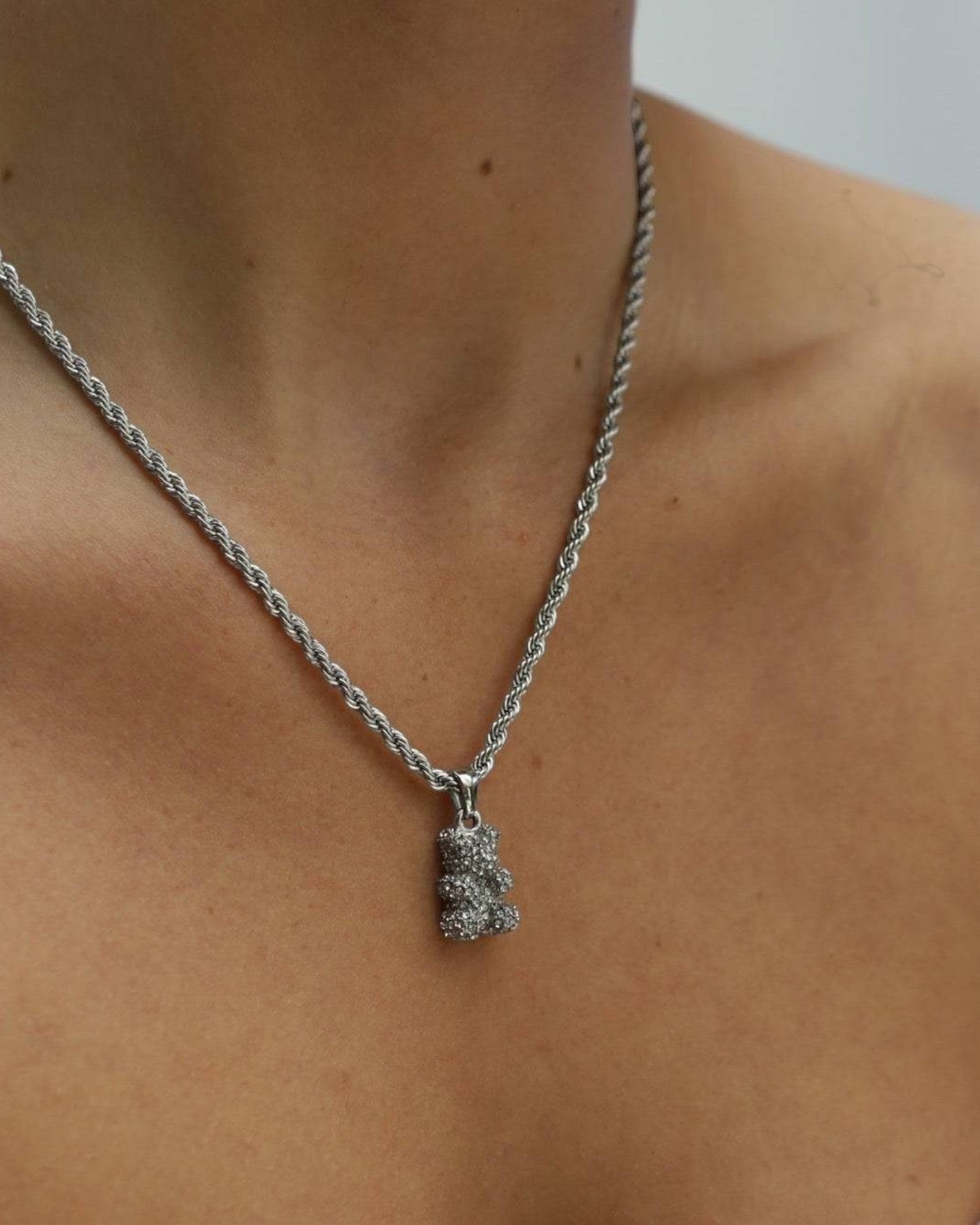 Réalta silver-toned pavé bear pendant necklace on a delicate rope chain worn around a woman's neck