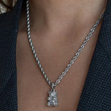 Réalta silver-tone pavé bear pendant necklace on a twisted rope chain worn around a neck.